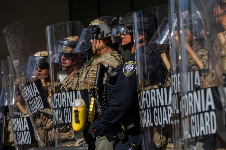 California National Guard members stand outside the Federal Building as people gather to protest in response to federal immigration operations in Los Angeles, on June 9, 2025. US President Donald Trump on June 9 ordered active-duty Marines into Los Angeles, vowing those protesting immigration arrests would be "hit harder" than ever. Protests in Los Angeles, home to a large Latino population, broke out on June 6, triggered by immigration raids that resulted in dozens of arrests of what authorities say are illegal migrants and gang members. (Photo by Apu GOMES / AFP) (Photo by APU GOMES/AFP via Getty Images)