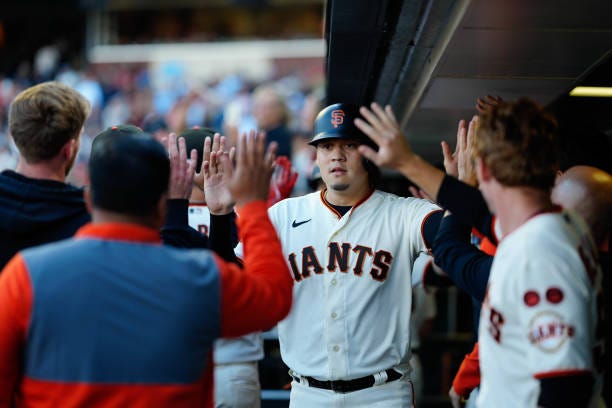 Wilmer Flores of the San Francisco Giants celebrating with teammates against the Atlanta Braves at Oracle Park on August 27, 2023 in San Francisco,...