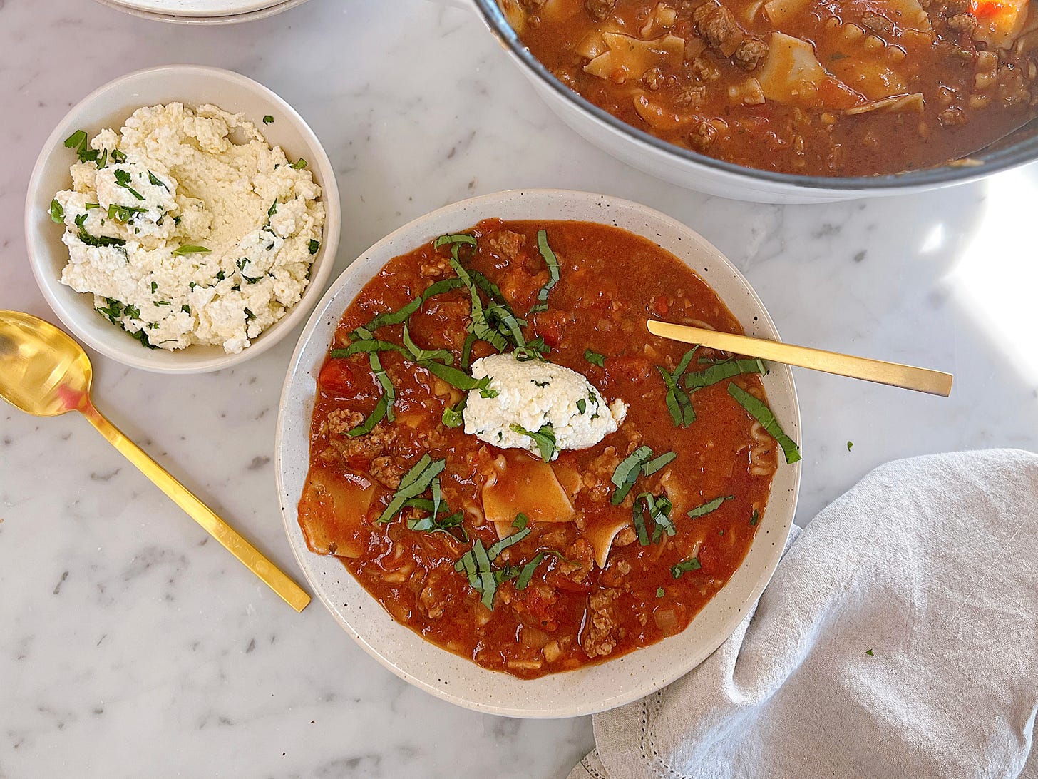 Gluten free and dairy free lasagna soup in a bowl with pot of soup