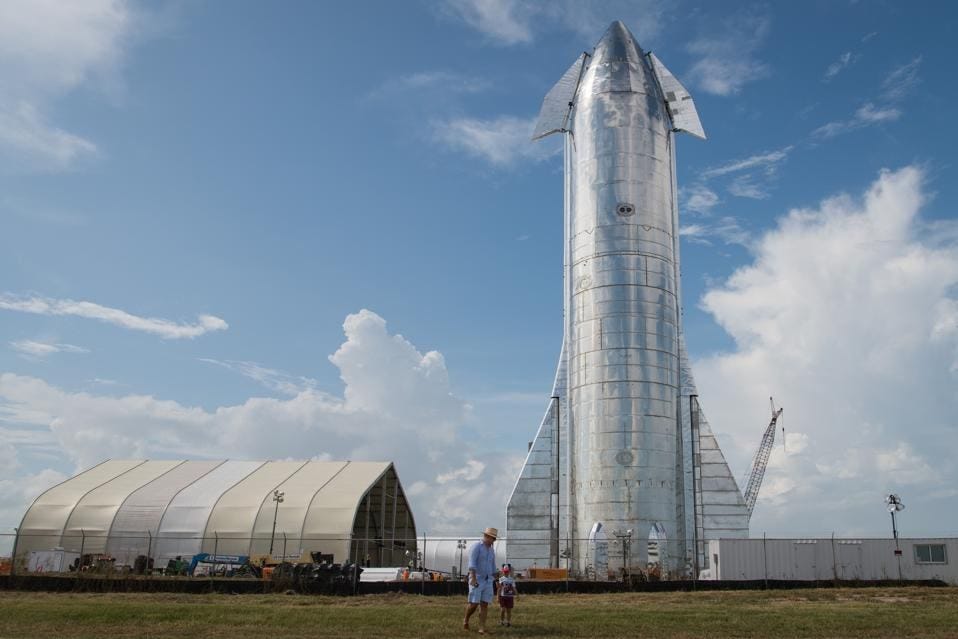 SpaceX's gigantic Starship capsule glows across the Starbase launch center 