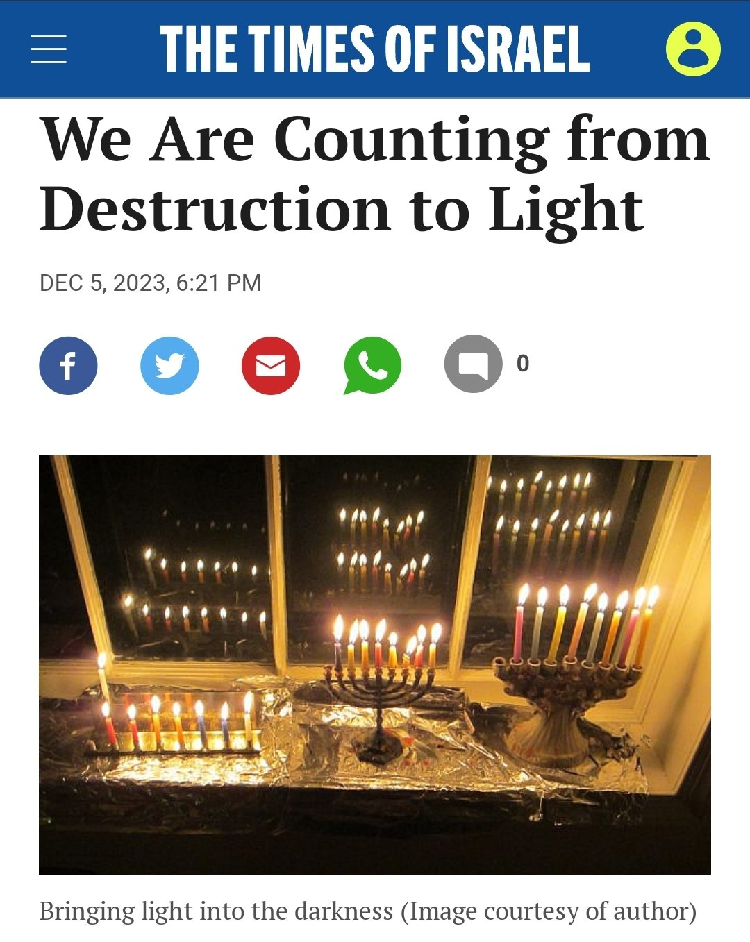The Times of Israel / We are Counting from Destruction to Light, December 5, 2023, 6:21PM, picture shows three lit candle menorahs with lights reflected many times in a window