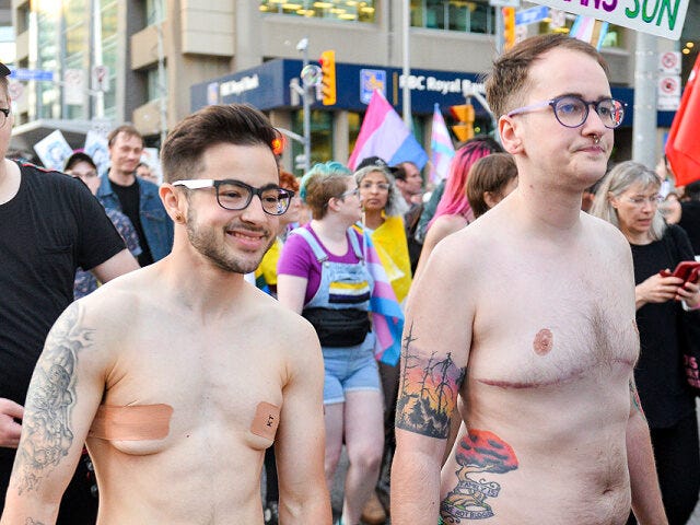 STREET, TORONTO, ONTARIO, CANADA - 2019/06/21: A naked protester smiles during the Trans march. Spectators displayed their support towards the transgender and non-binary people while demonstrating on the streets of Toronto in a Trans March during the Pride Month. (Photo by Anatoliy Cherkasov/SOPA Images/LightRocket via Getty Images)