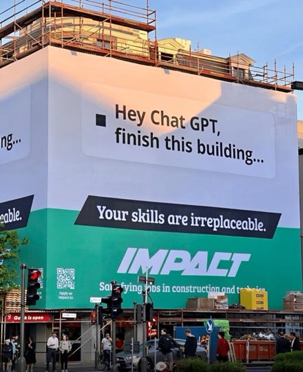 A photo of a building site wrap advert for employment agency IMPACT. The headline reads "Hey ChatGPT, finish this building..." The strapline reads "Your skills are irreplaceable"