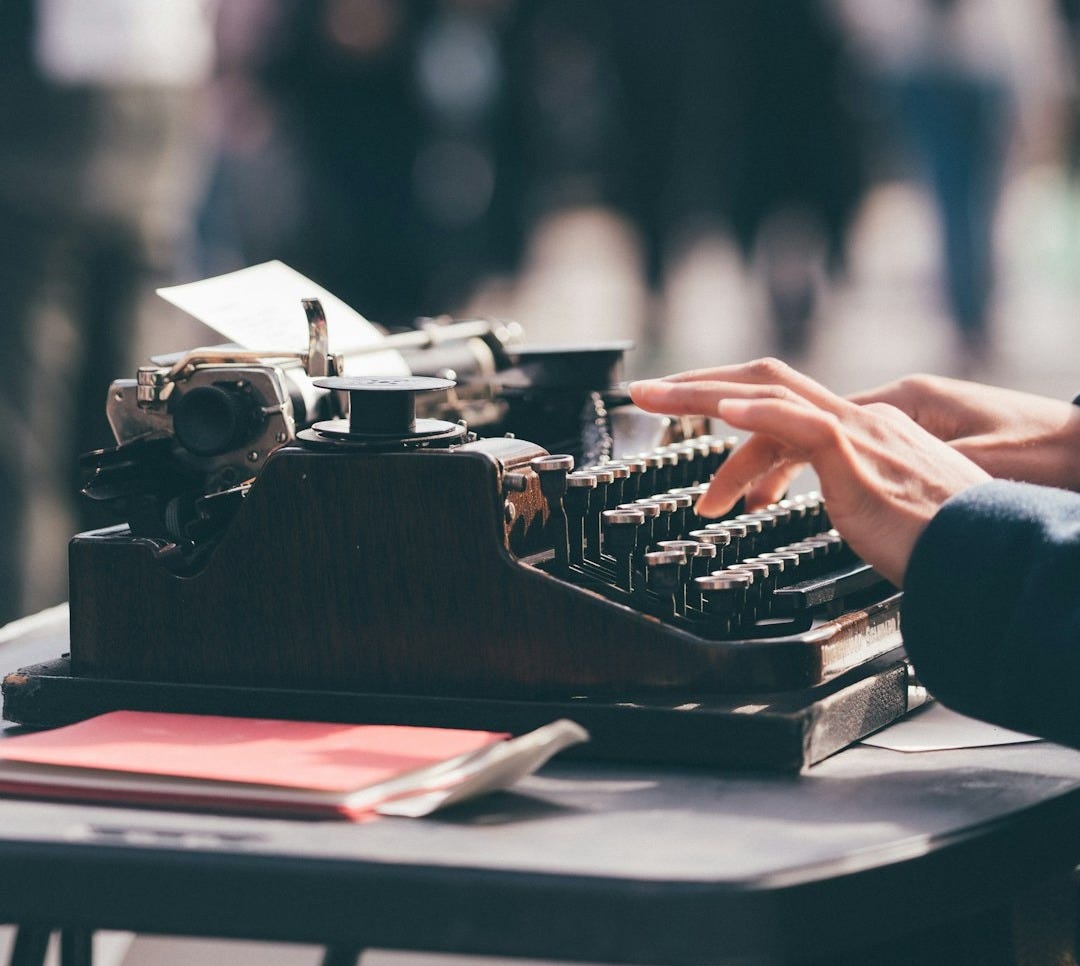 person using black typewriter