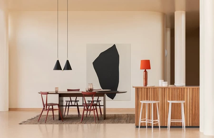 collection of ercol pieces from a walnut dining table set to white ercol bar stools against an oak breakfast bar