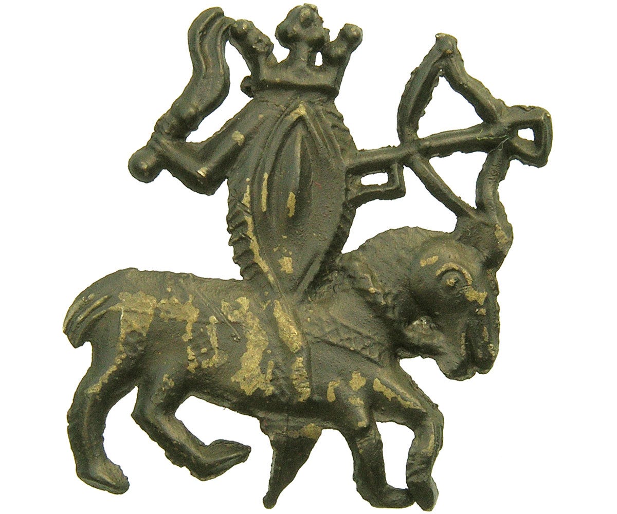A medieval lead-tin badge featuring a vulva riding a horse A medieval lead-tin badge featuring a vulva riding a horse