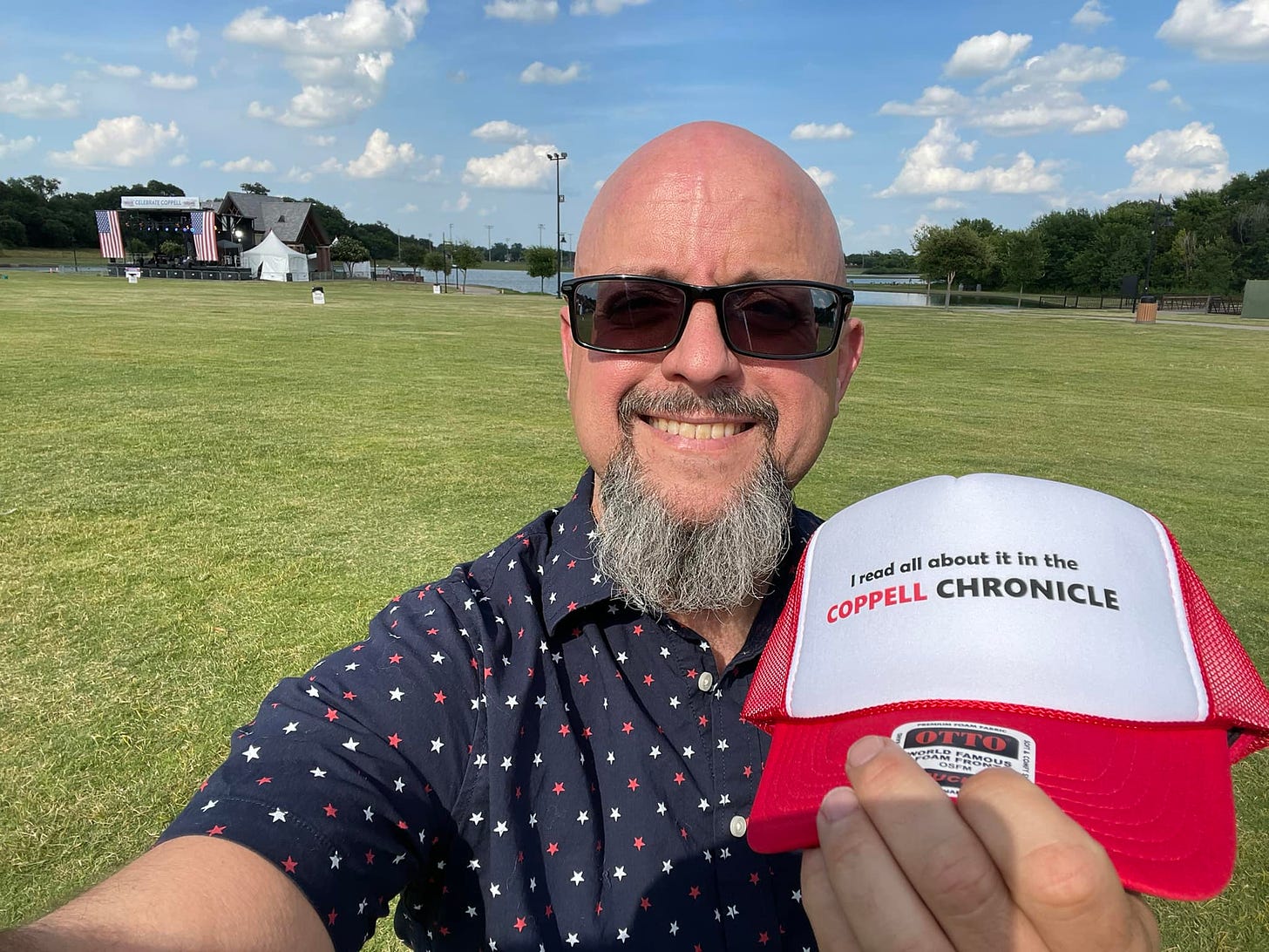 Bald doofus displaying a Coppell Chronicle trucker cap