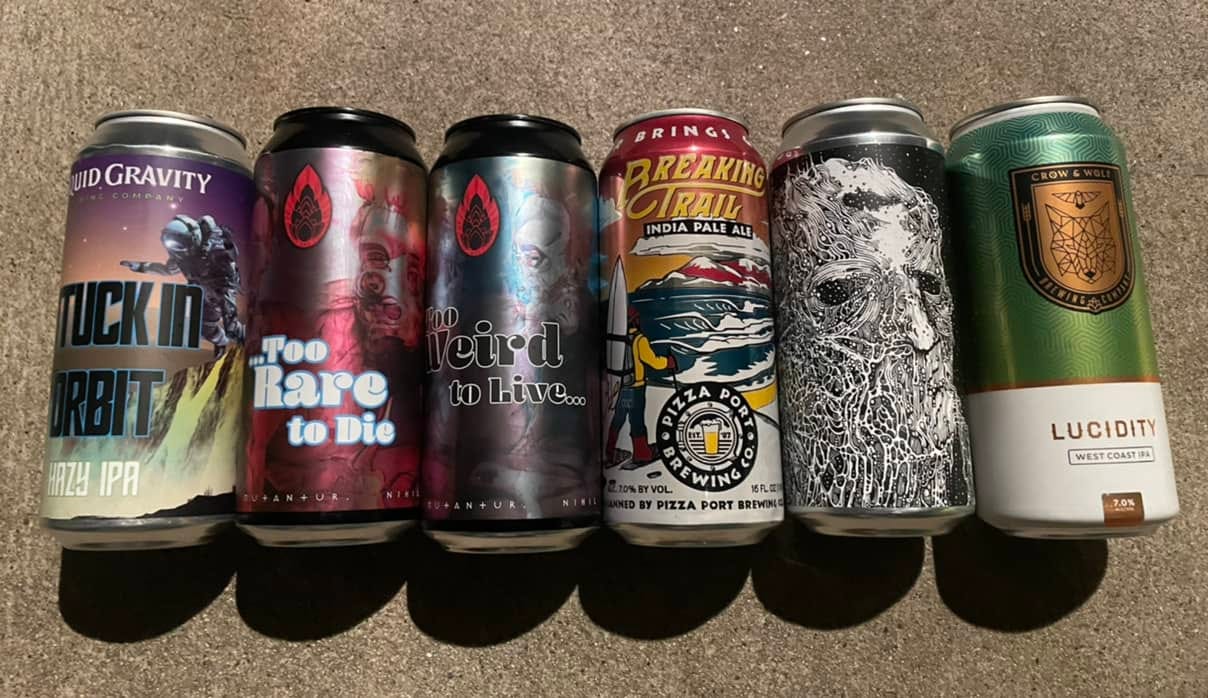 A lineup of six cans of different IPAs