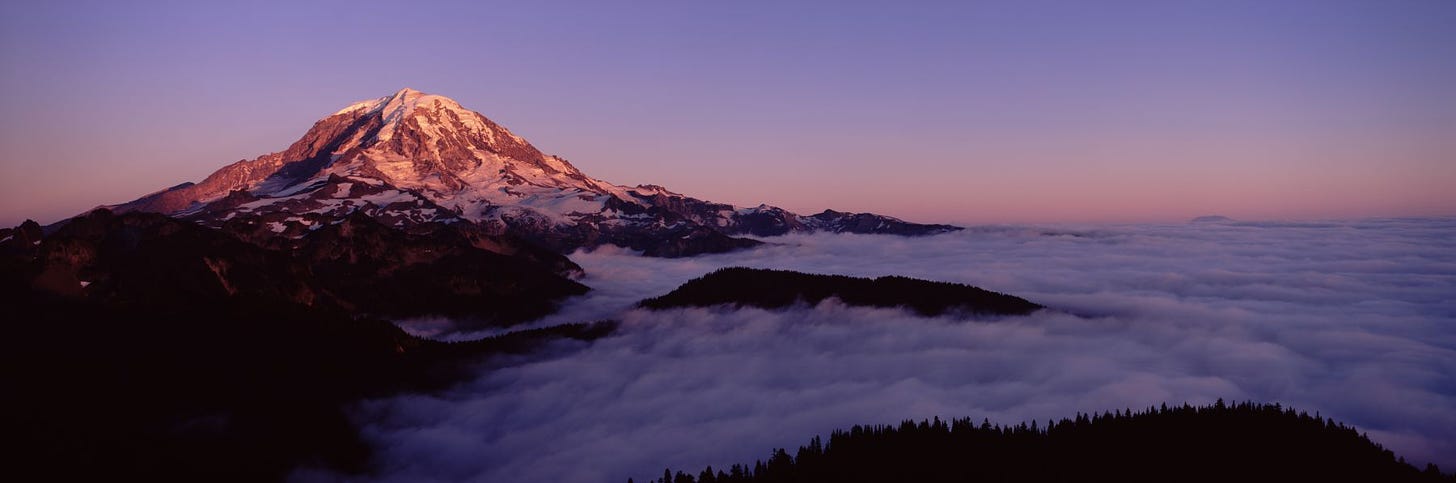 Sea of clouds with mountains in the background, Mt Rainier, Pierce County,  Washington State, USA