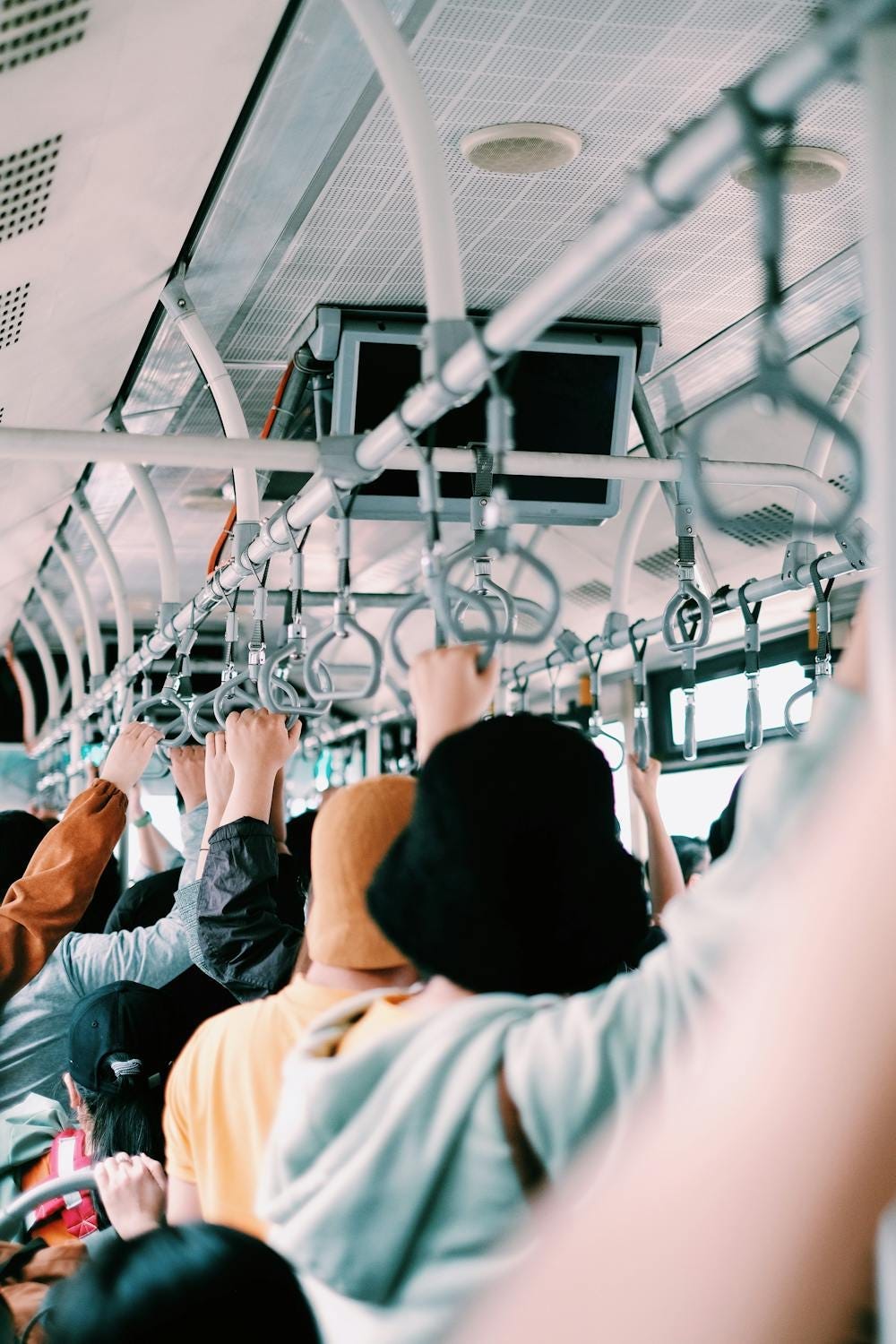 people standing in a crowded bus