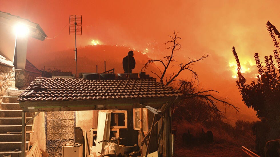 Climate change is leading to more extreme weather such as wildfires, like this one in the Greek village of Kallithea in September 2024.