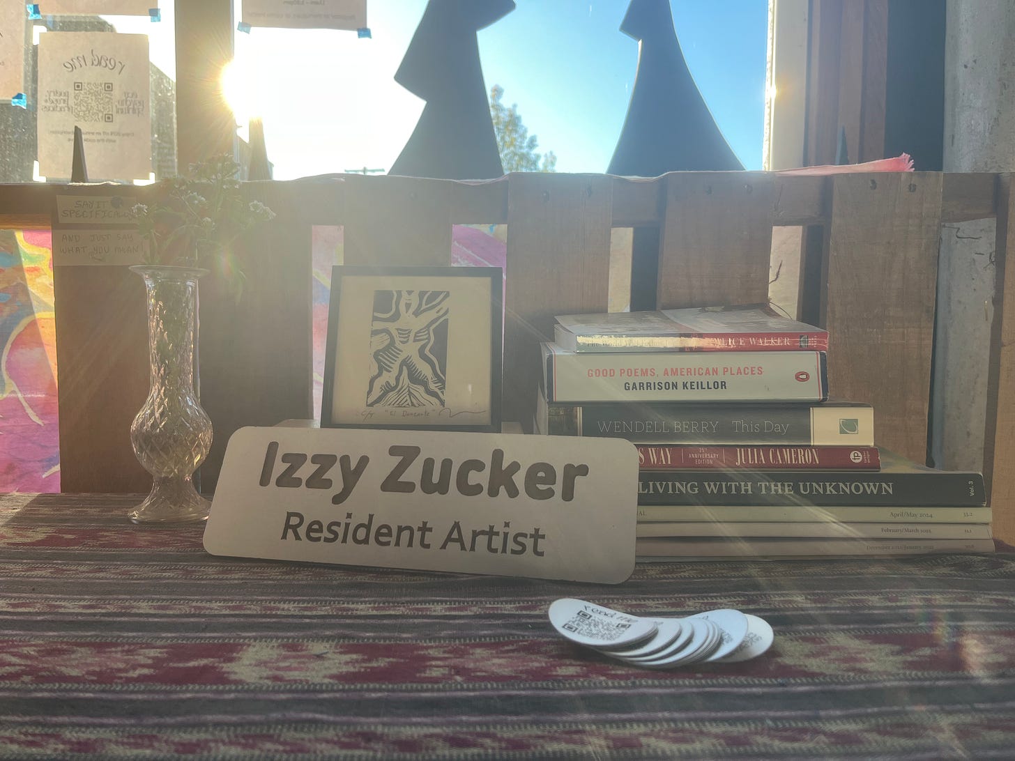 Desk name tag that says "Izzy Zucker" resident artist