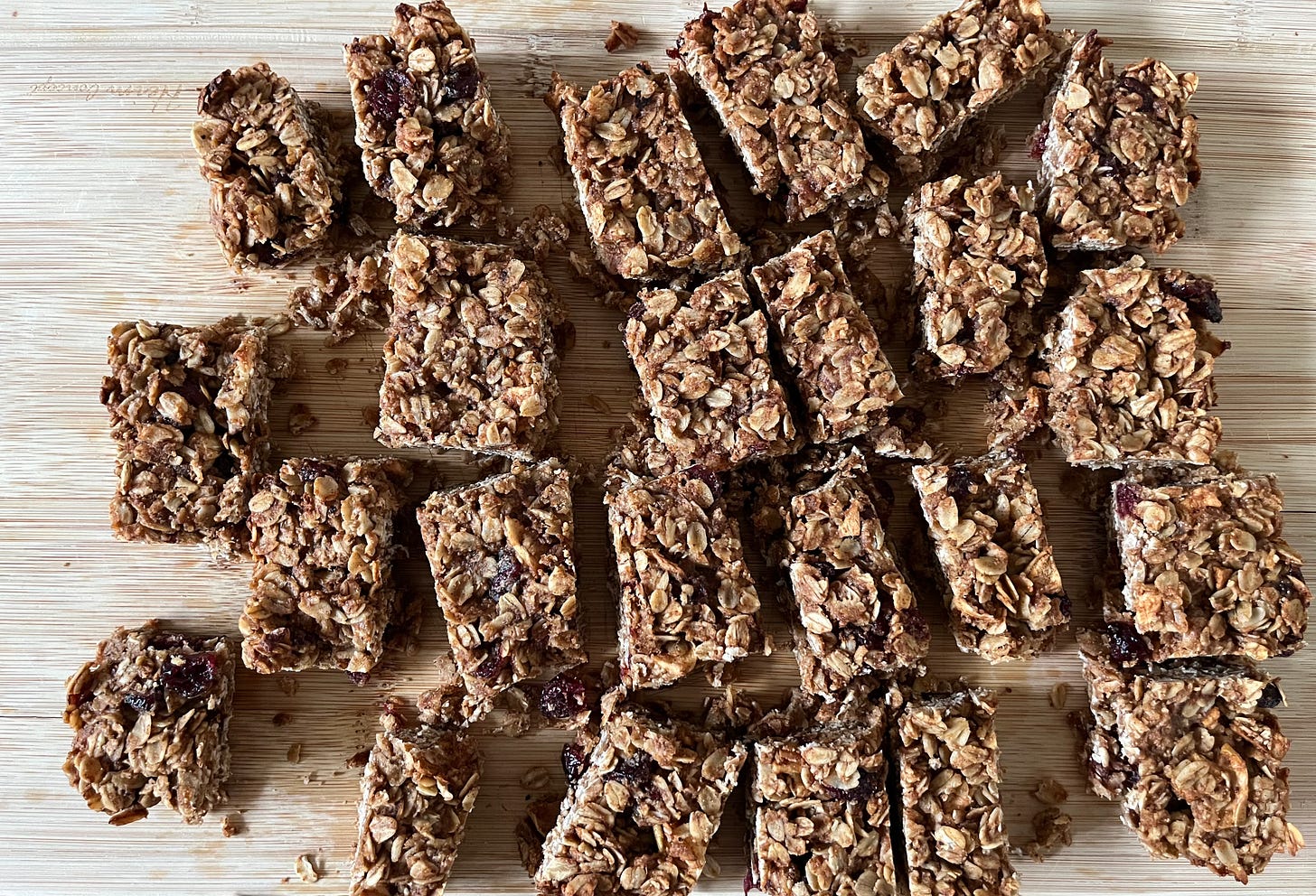 Overhead view of granola bars on a cutting board.