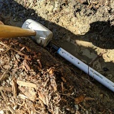 Banging Pipe with Mallet
