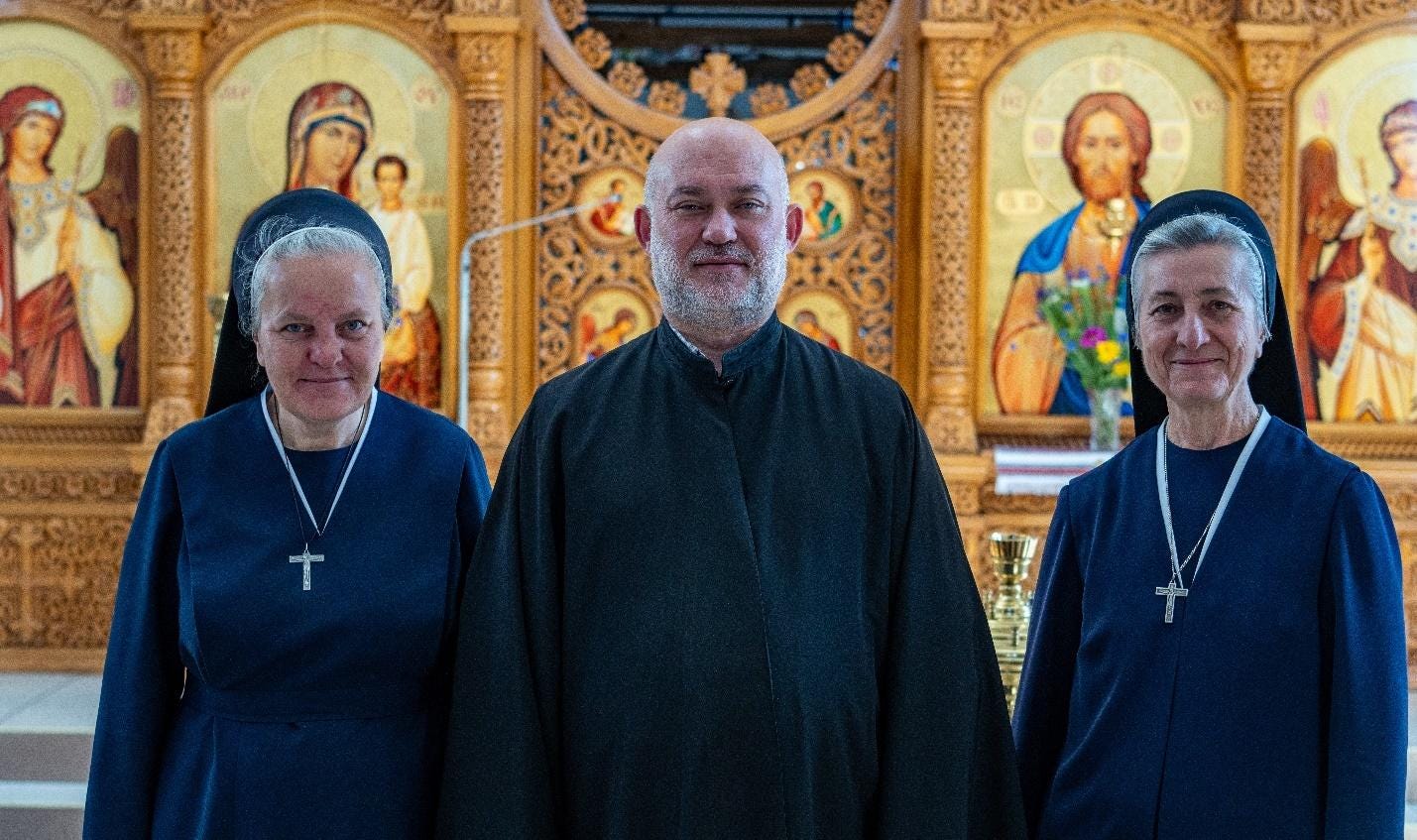 A group of people standing in front of a religious picture

Description automatically generated