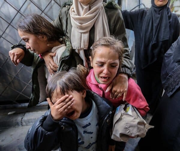 A photograph of three children crying in Gaza.