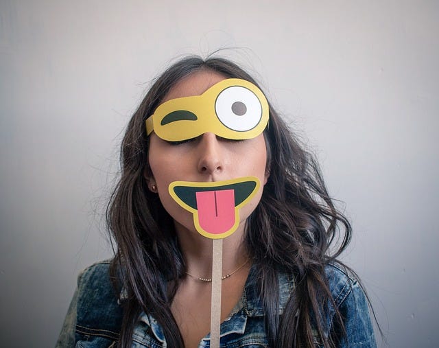 Woman with a mask based on winking-face-with-stuck-out-tongue emoji