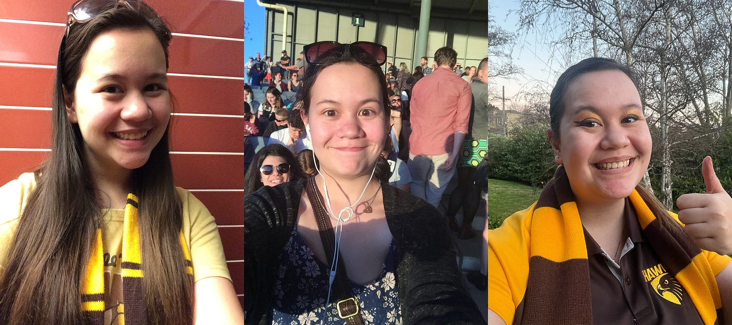 From left to right, this image shows three photographs of Julia. She is a woman with long brown hair and she is older in each photo. The first one was taken on the morning of the AFLM Grand Final 2015 and she's wearing a Hawks t-shirt and scarf. The middle one was taken at the first ever AFLW game in 2017 and she is wearing a blue floral dress, grey cardigan, sunglasses and wired headphones. She looks annoyed because she's just found out that her friends have been locked out. The third photograph shows her on the day of the first every Hawthorn AFLW game wearing a Hawks shirt and scarf. She's wearing matching brown and gold eye make-up, smiling and holding her hand in a thumbs up.