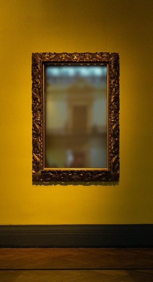 A brass picture frame with a blurry image in the center.
