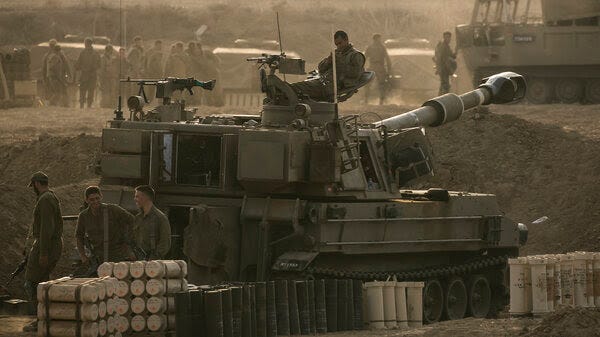  Israeli soldiers sit on an artillery unit near the Israeli border with the Gaza Strip, in Netivot, Israel, Oct. 22. 