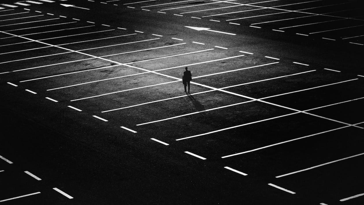 Free Man Standing on Parking Lot Stock Photo