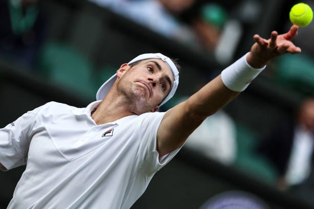 John Isner of The United States serves in the Men's Singles Second Round Match against Andy Murray of Great Britain during day three of The...