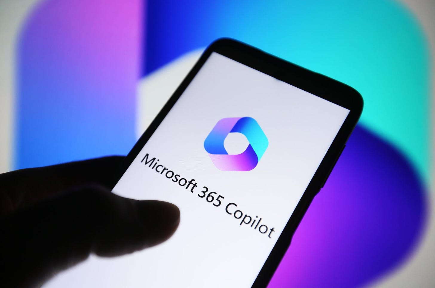 Image 4: Microsoft Copilot Logo on a phone screen being held by a human hand