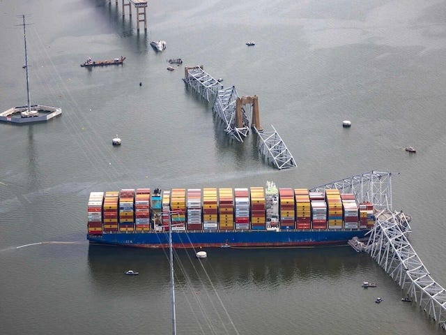 BALTIMORE, MARYLAND - MARCH 26: In an aerial view, the cargo ship Dali sits in the water after running into and collapsing the Francis Scott Key Bridge on March 26, 2024 in Baltimore, Maryland. According to reports, rescuers are still searching for multiple people, while two survivors have been pulled from the Patapsco River. A work crew was fixing potholes on the bridge, which is used by roughly 30,000 people each day, when the ship struck at around 1:30am on Tuesday morning. The accident has temporarily closed the Port of Baltimore, one of the largest and busiest on the East Coast of the U.S. (Photo by Tasos Katopodis/Getty Images)