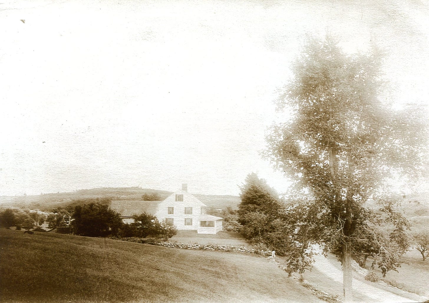 House with rock wall and road