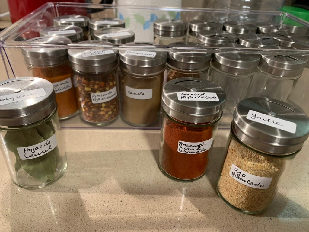 The completed jars are placed in a clear box, ready for the pantry shelf.