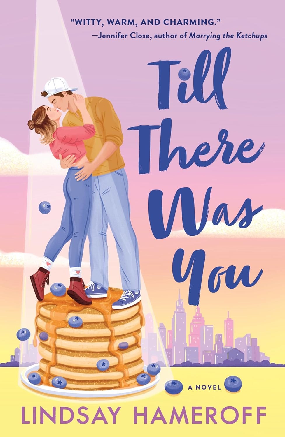 copy of Till There Was You by Lindsay Hameroff, showing a white couple embracing and about to kiss standing on a stack of blueberry pancakes, and then the title in a cute font with a blueberry over the i