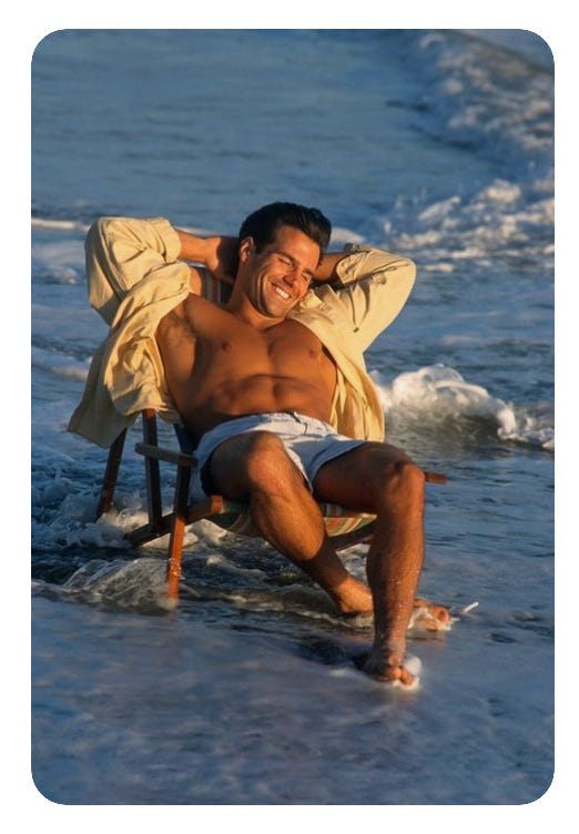 stock image looking photo of a guy at a beach relaxing with his shirt open