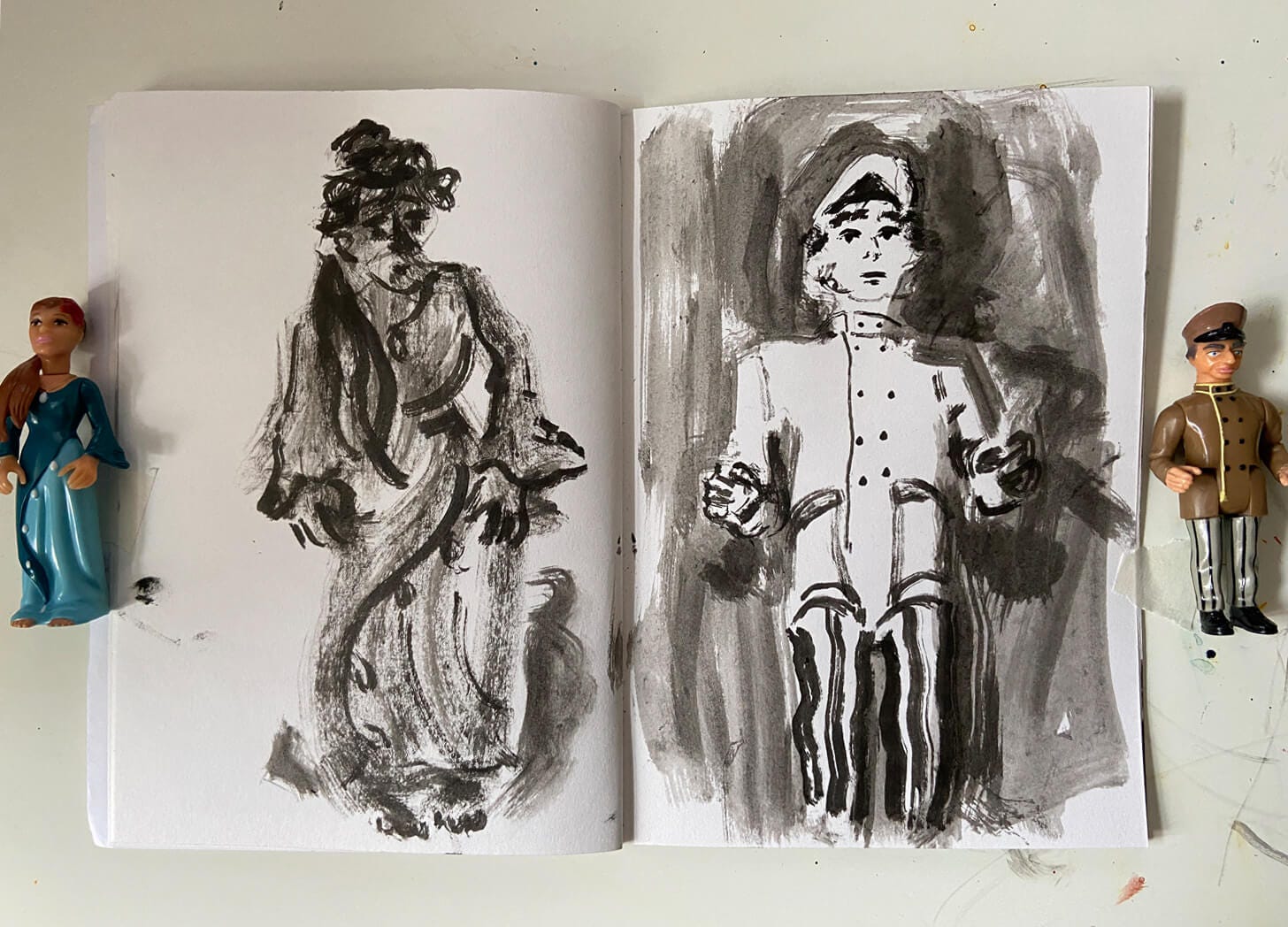 Sketchbook drawings in ink of plastic toy figures. Drawings by illustrator Nanette Regan