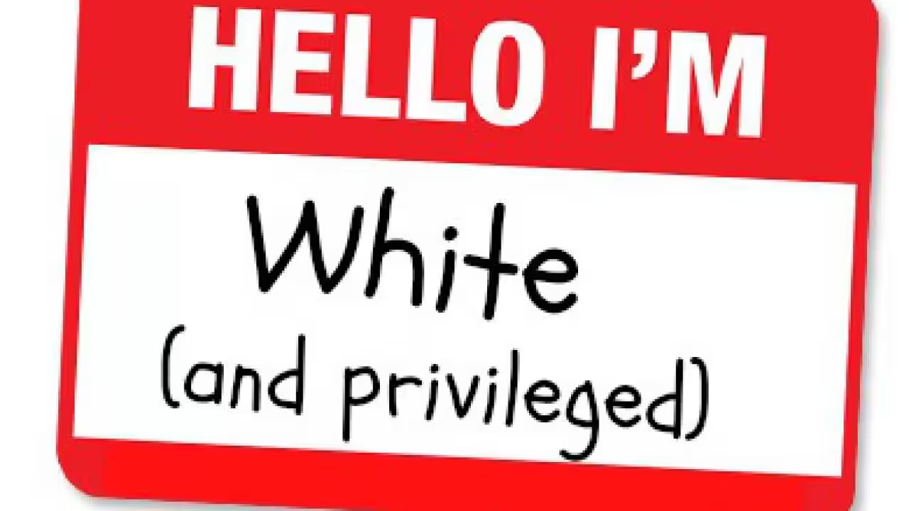 A red and white name tag, like someone would wear at a conference, that says Hello I'm White (and privileged)