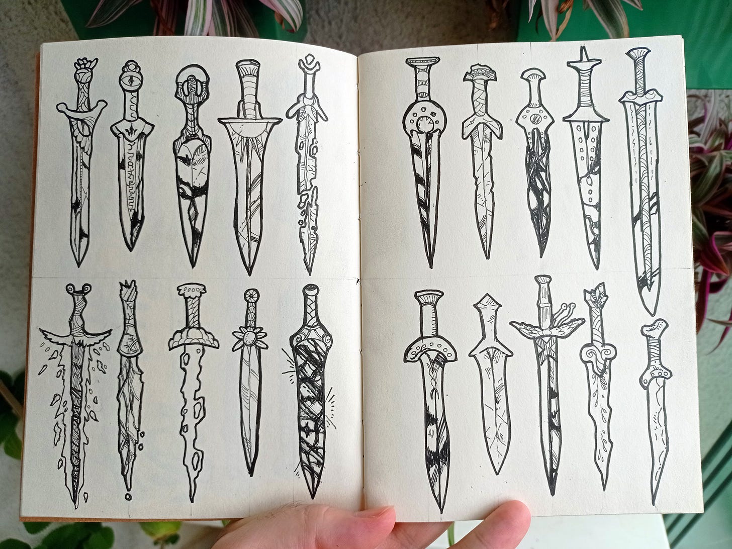 sketchbook page photo with drawings of 20 fantasy swords with different aspects, all with an ancient design.