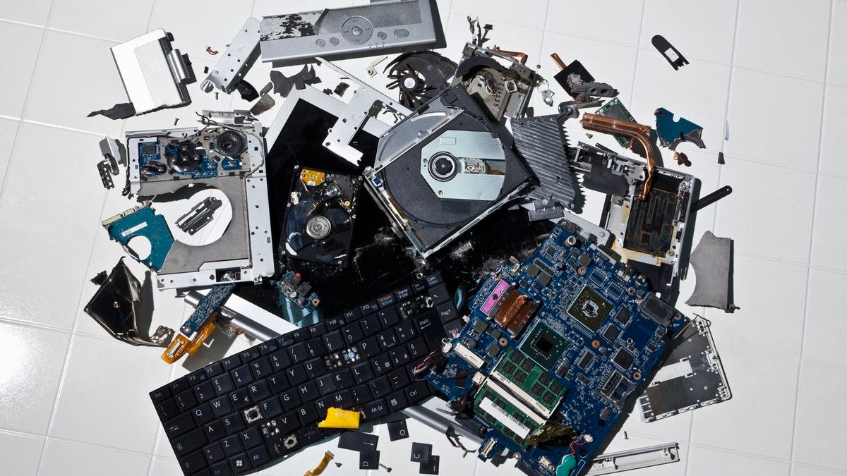 A pile of smashed computer parts on the floor