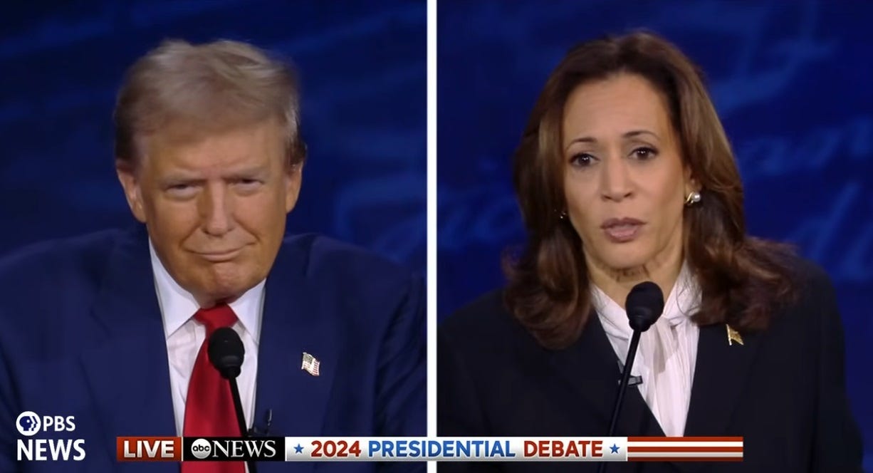 video screenshot of debate showing Kamala Harris speaking and Donald Trump smirking