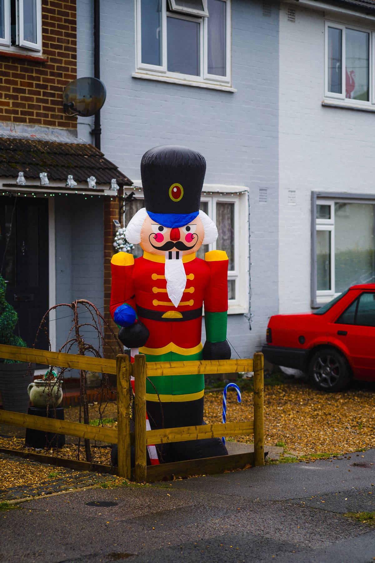 Inflatable nutcracker toy solider figure outside a suburban semi-detached house