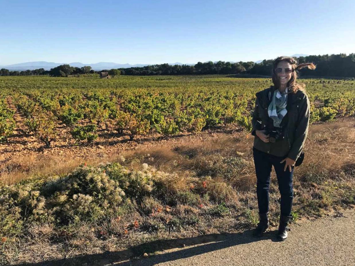 wine journalist near Southern Rhône Valley vineyard being blown away by the Mistral winds