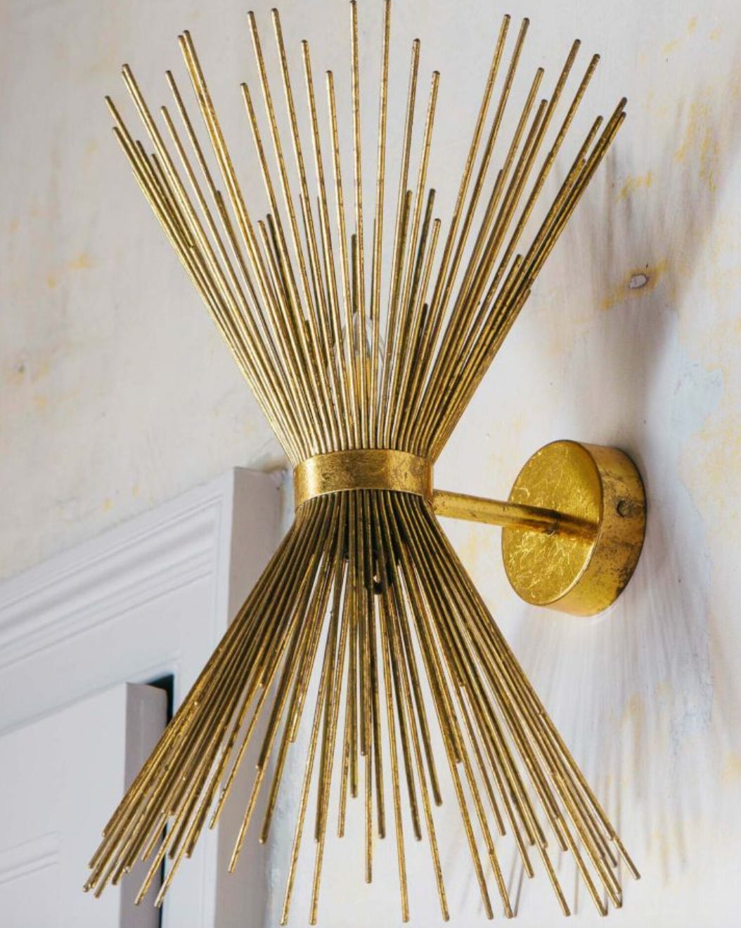 spiked wall light in brass