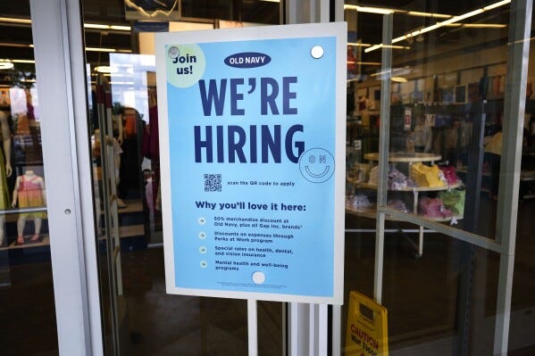 A hiring sign is displayed at a retail store in Vernon Hills, Ill., Monday, June 12, 2023. The most-anticipated recession probably in modern U.S. history still hasn't arrived. Despite higher borrowing costs, thanks to the Federal Reserve's aggressive streak of interest rate hikes, consumers keep spending, and employers keep hiring. (AP Photo/Nam Y. Huh)