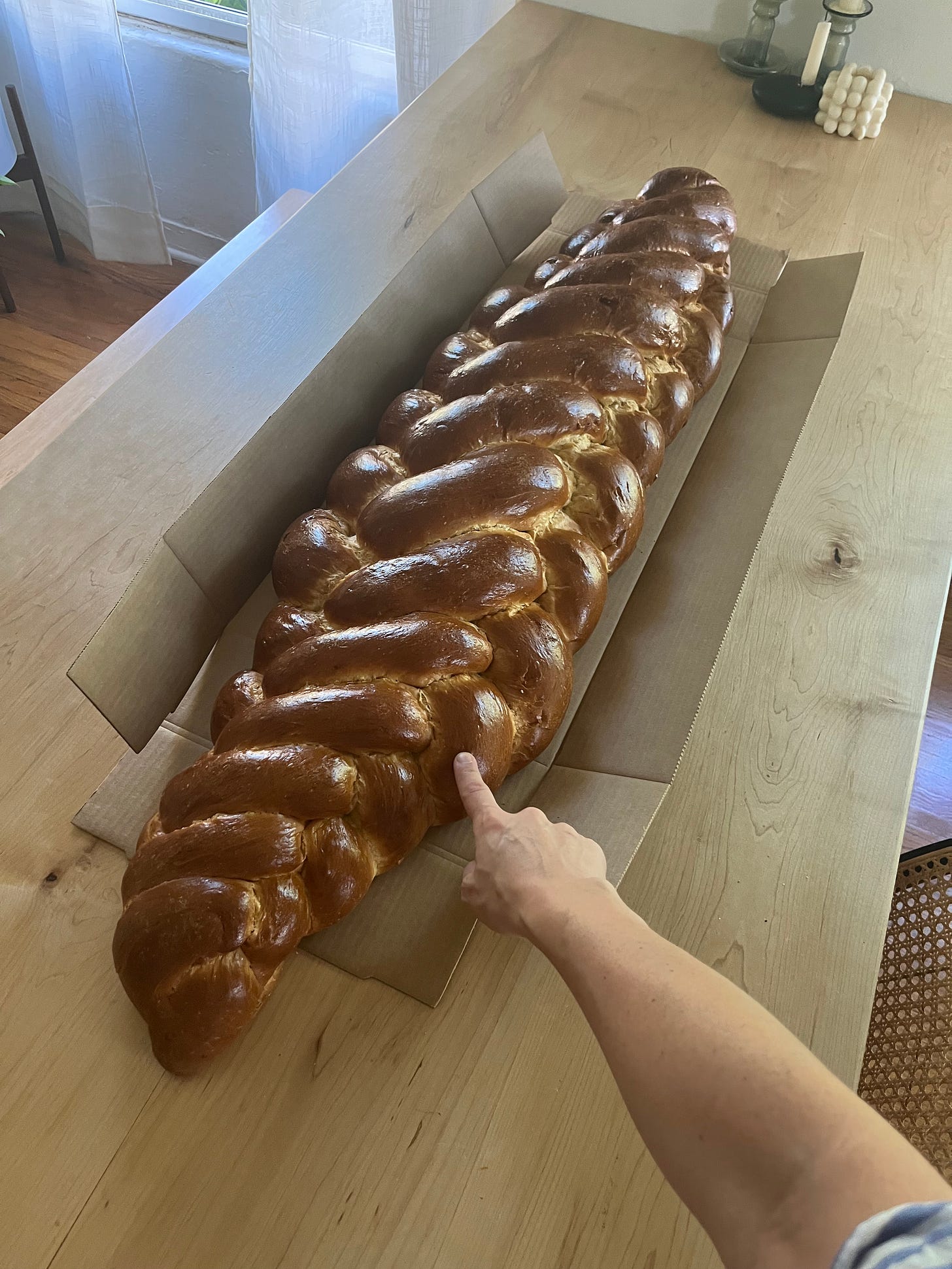 Challadad challah bread on a dining room table