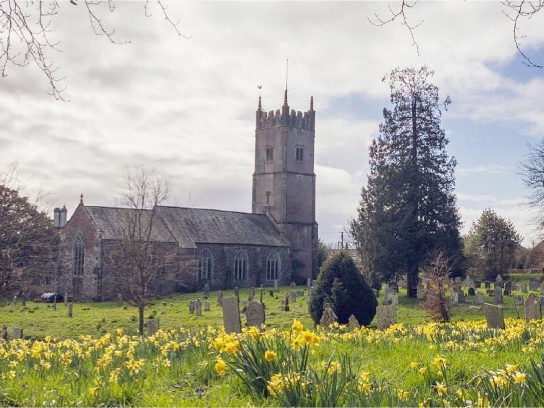 Photo of a village church in Devon with daffodils by Glyn Dewis