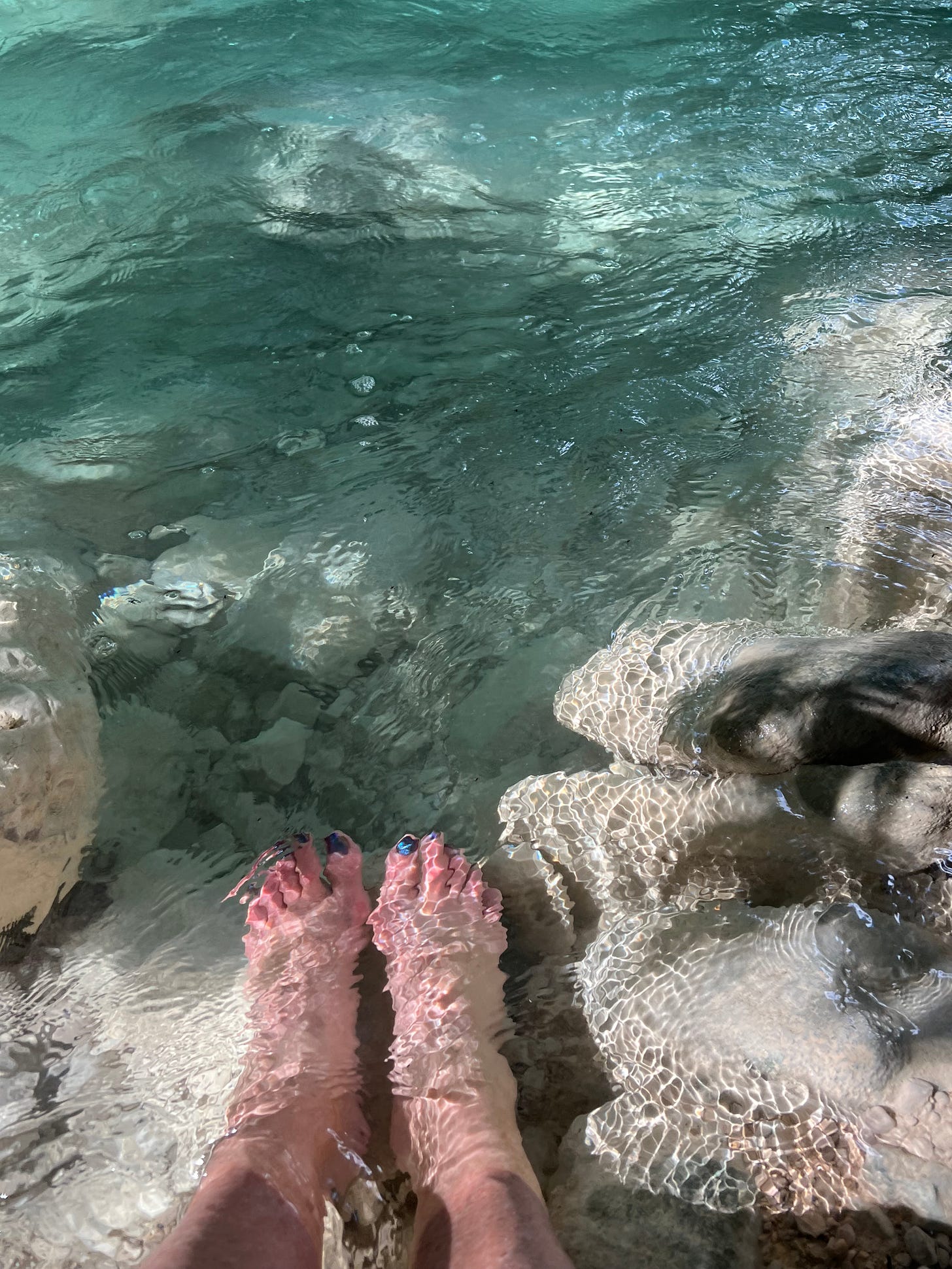 image of feet in cool clear water
