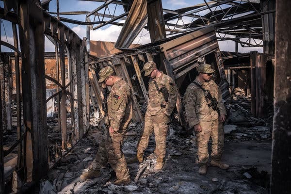 U.S. military personnel surveying the damage at Al Asad Air Base in Anbar, Iraq, after a strike by Iranian missiles last month.
