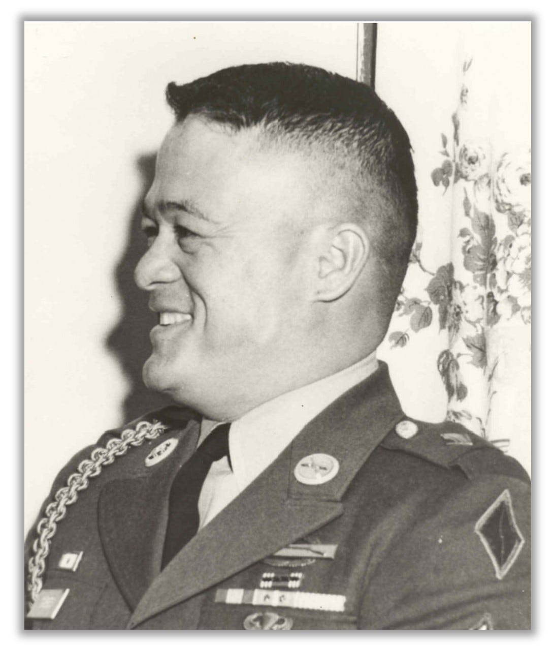 Maximo Yabes is shown in uniform, but it's a profile shot.  He is smiling.