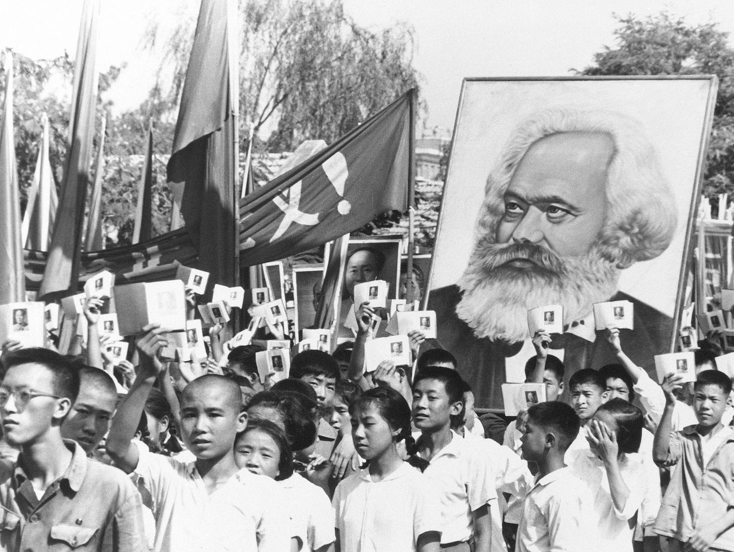In this Sept. 14, 1966 file photo, youths are seen at a rally during the height of the Red Guard upheaval waving copies of the collected writings of Communist Party Chairman Mao Zedong, often referred to as Mao's Little Red Book and carrying a poster of Karl Marx.