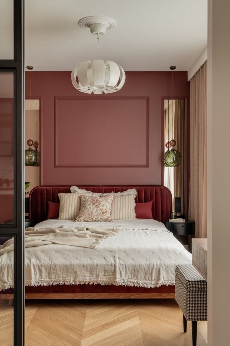 This may contain: a bed sitting in the middle of a bedroom next to a window