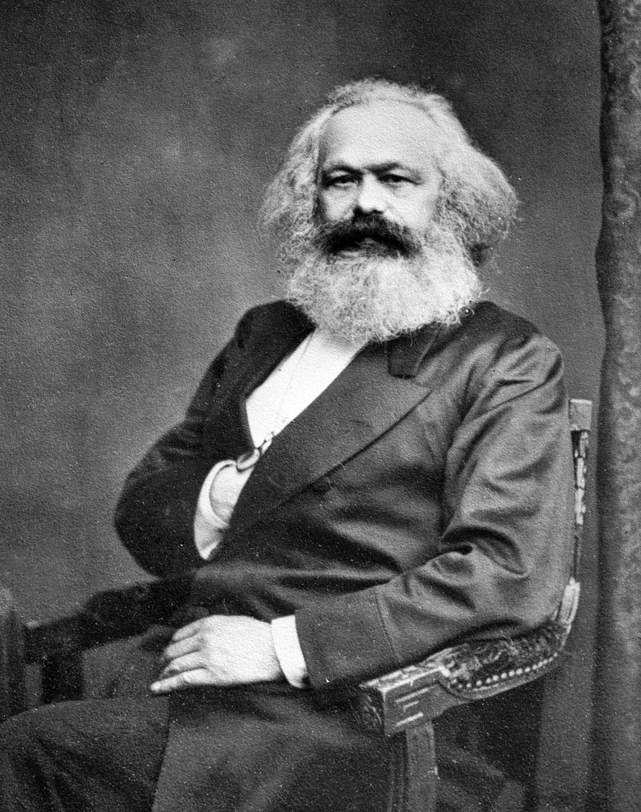 Photo shows Karl Marx, 1875. Photo by John Jabez Edwin Mayal - International Institute of Social History, Public Domain