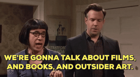 GIF: Fred Armisen, dressed as a woman on SNL, says, "We're gonna talk about films, and books, and outsider art."